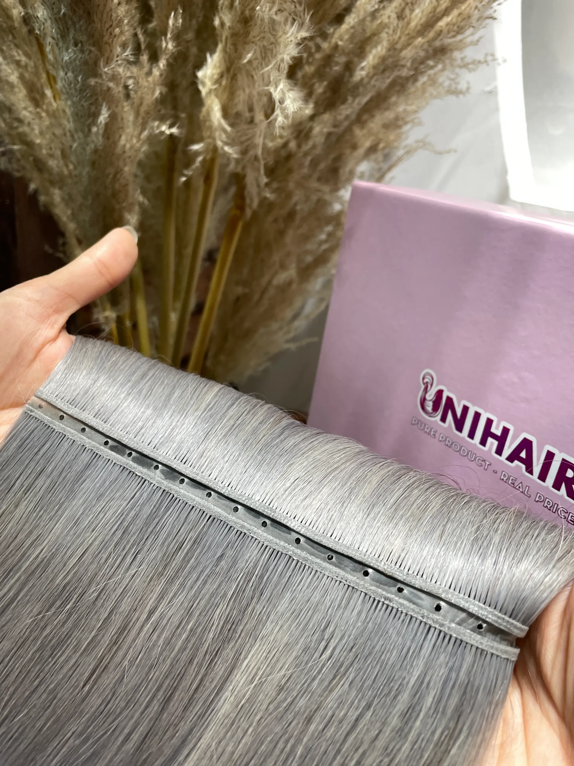 Double Genius Weft Vietnamese human hair bundle showing thin double-layer construction Double Genius Weft Vietnamese human hair bundle showing thin double-layer construction