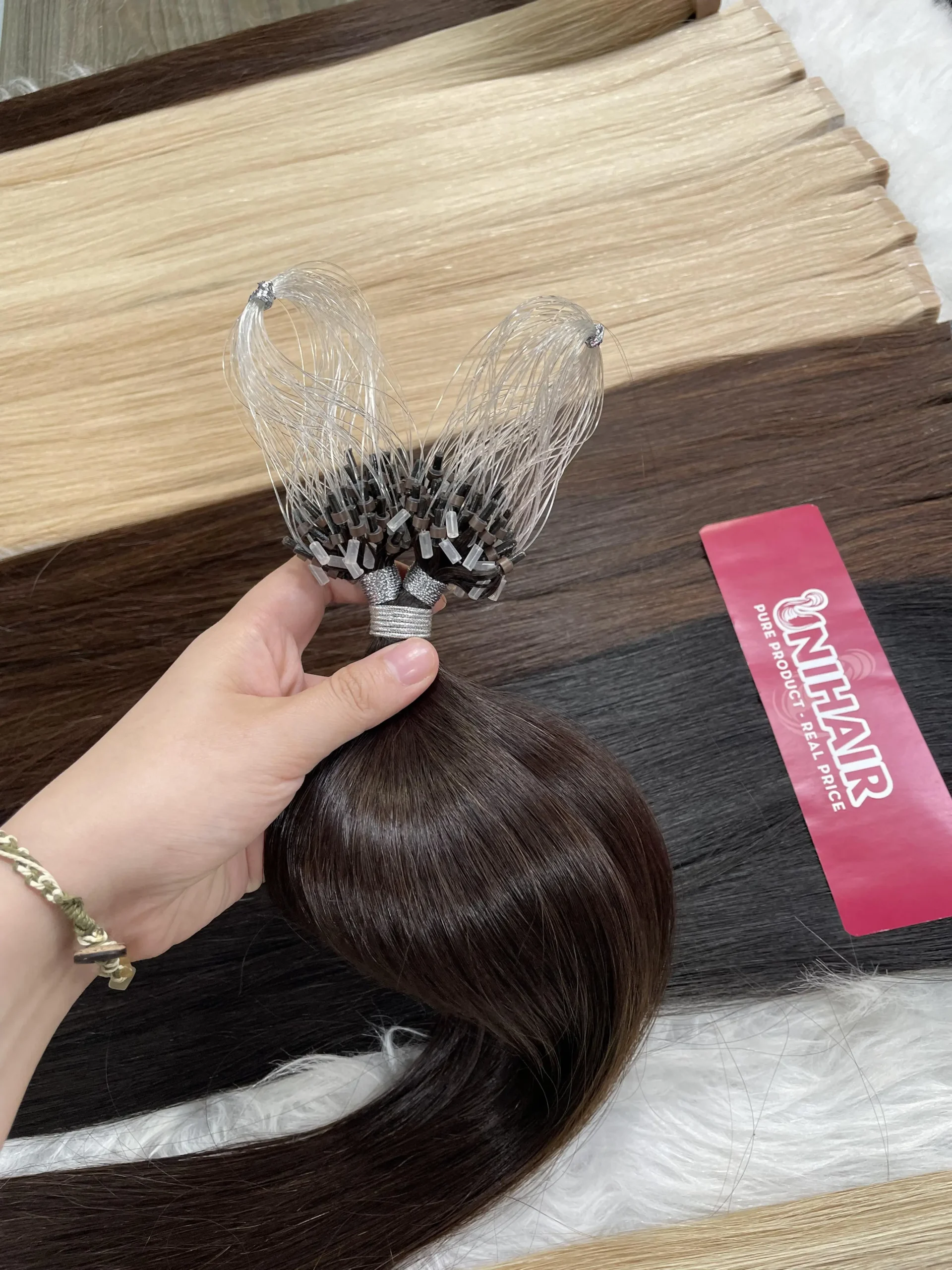 Micro Ring reusable bead hair extensions close-up with silicone-lined rings for salon installation