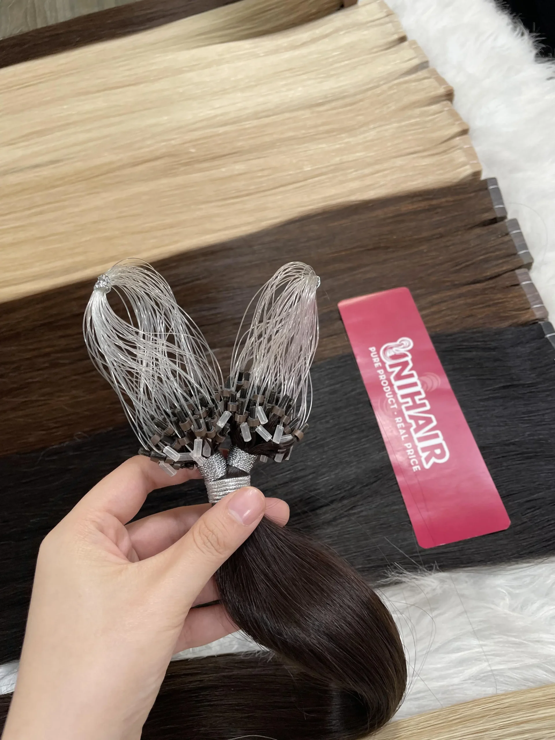 Micro Ring hair extension strands showing bead attachment detail for professional move-up service